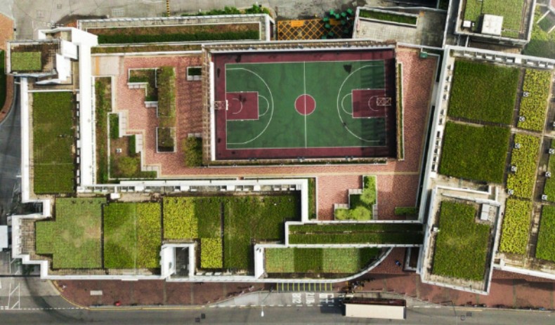 A top-down perspective of the Triumph Arch Residential Complex, highlighting its rainwater collection system and rooftop greenery.